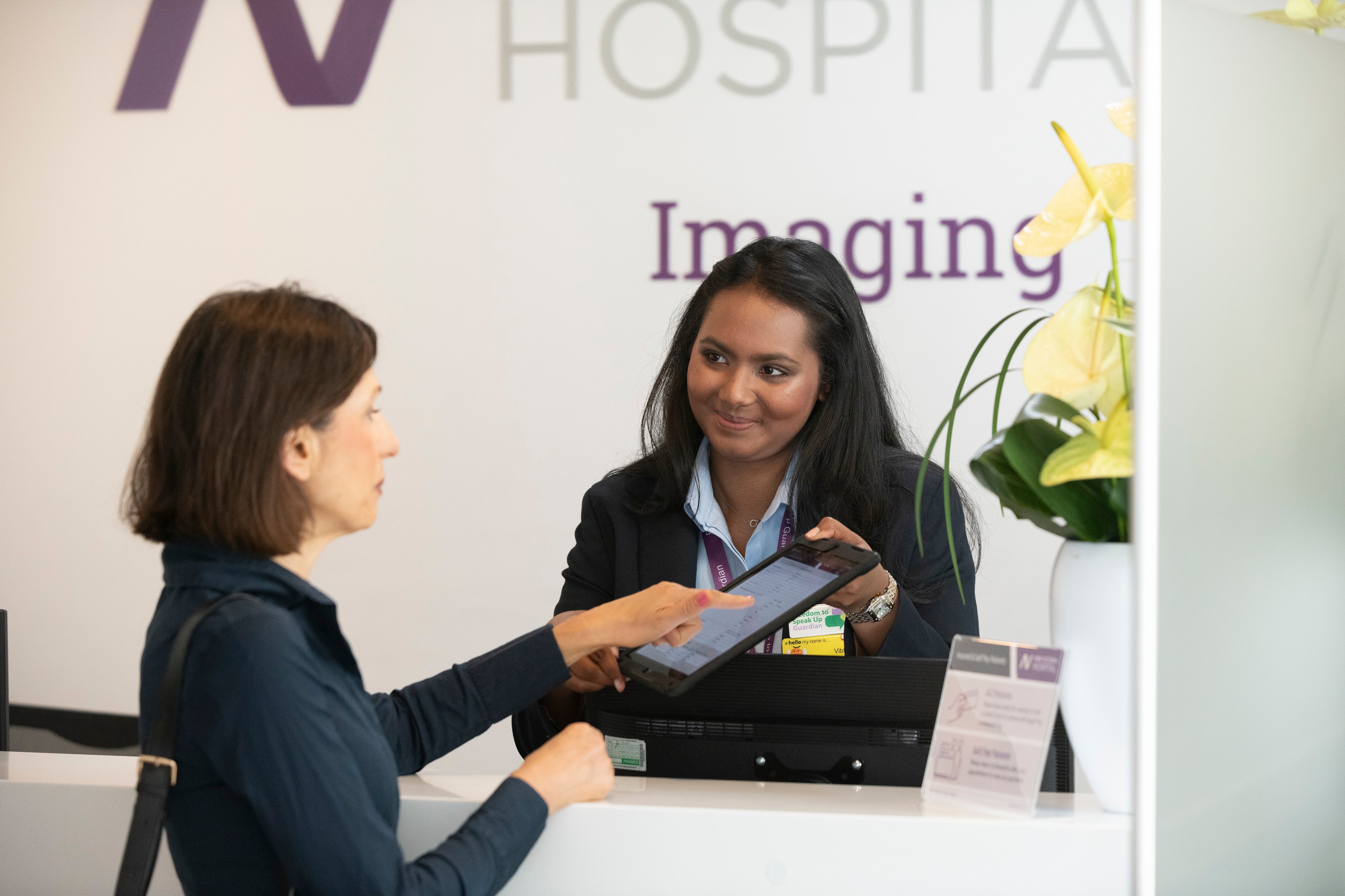 women speaking to a women about the imaging counter
