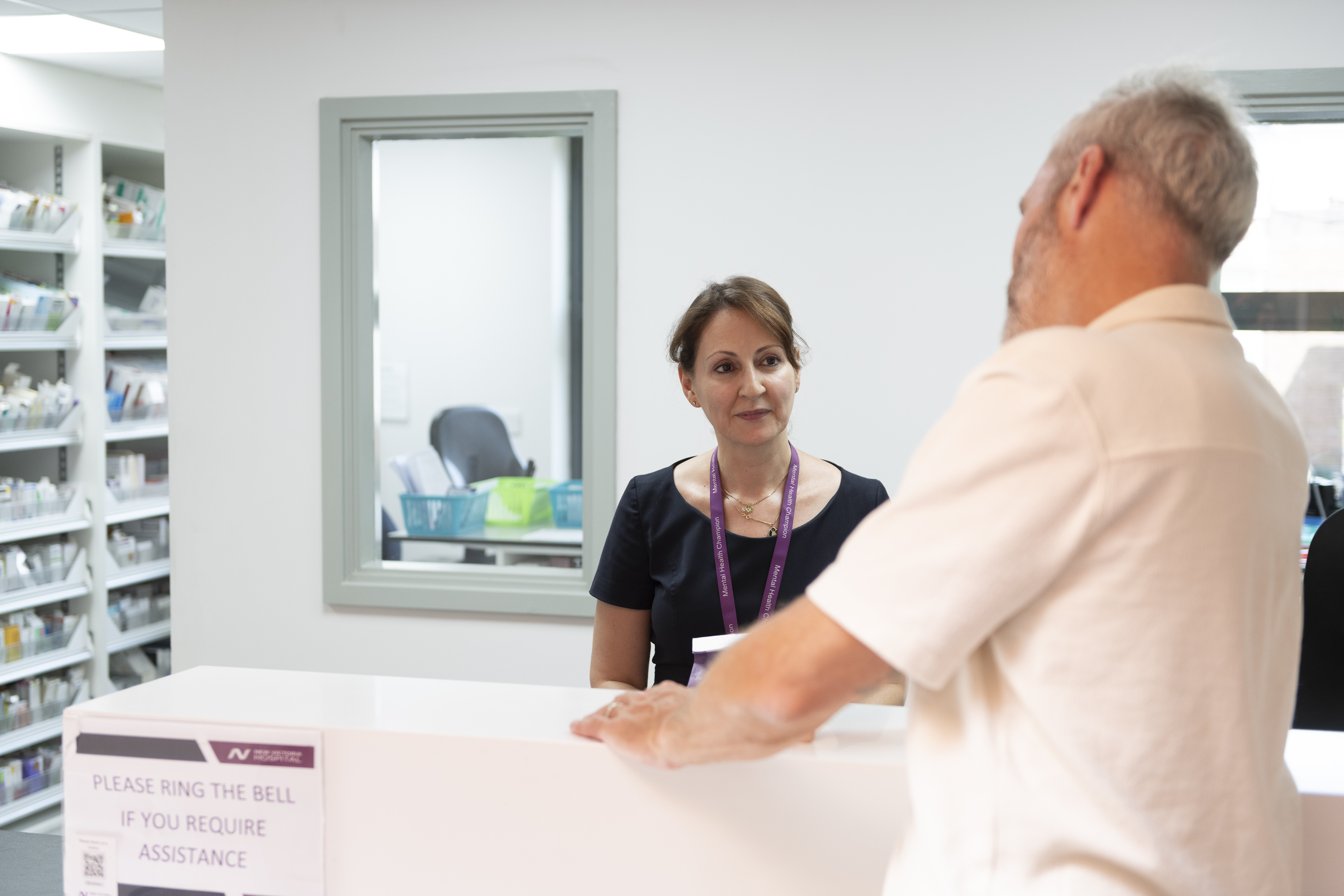 man going to a desk in New Victoria Hospital