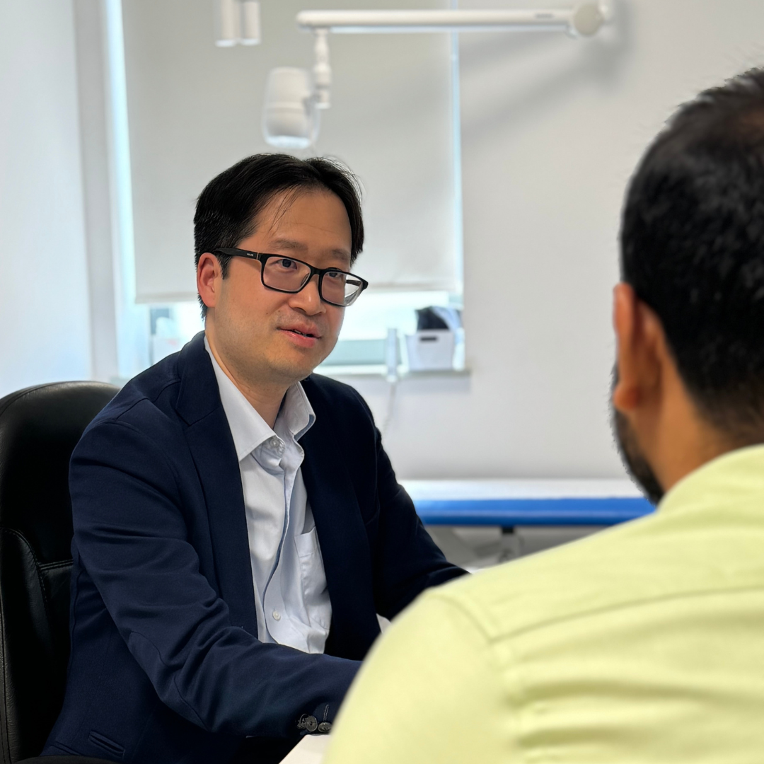 GP David Chan with a male patient