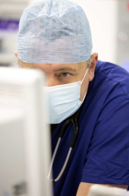 nurse looking at a screen during a breast lumpectomy