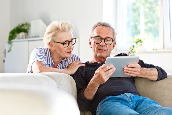 Two people viewing an iPad
