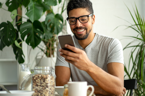 Smiling man on mobile phone at home