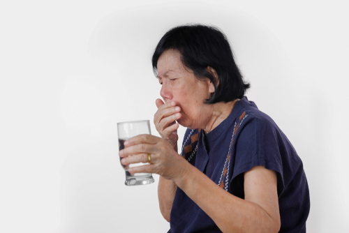 Woman experiencing swallowing difficulty